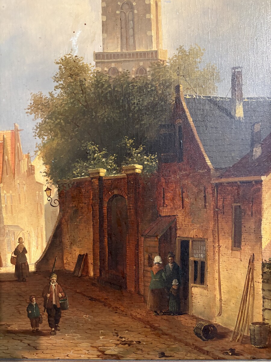 Painting ‘View of an Old Dutch Town’ oil on panel, 19th century Decorative painting in a large gilded frame depicting an old town, a street with old houses, a church, a gate with a municipal garden and various figures. 