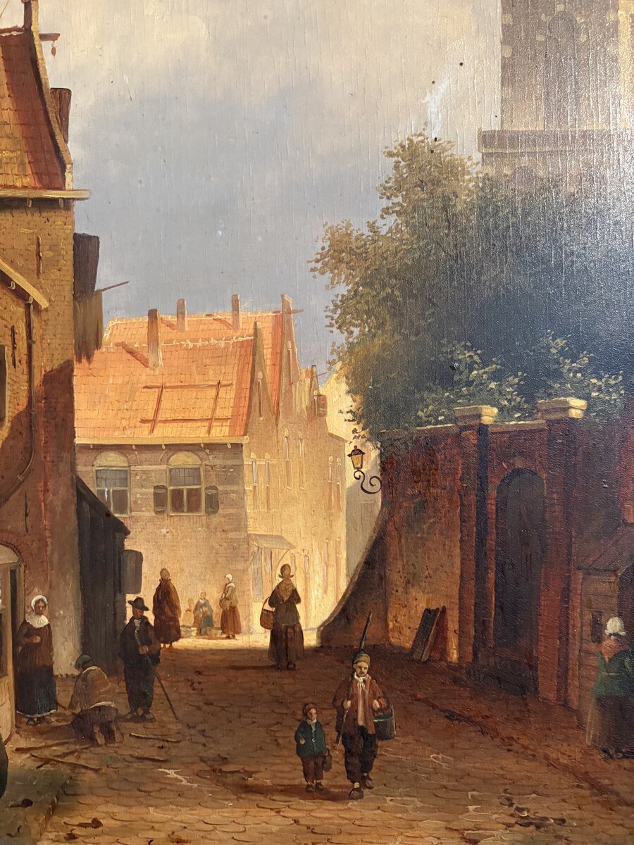 Painting ‘View of an Old Dutch Town’ oil on panel, 19th century Decorative painting in a large gilded frame depicting an old town, a street with old houses, a church, a gate with a municipal garden and various figures. 
