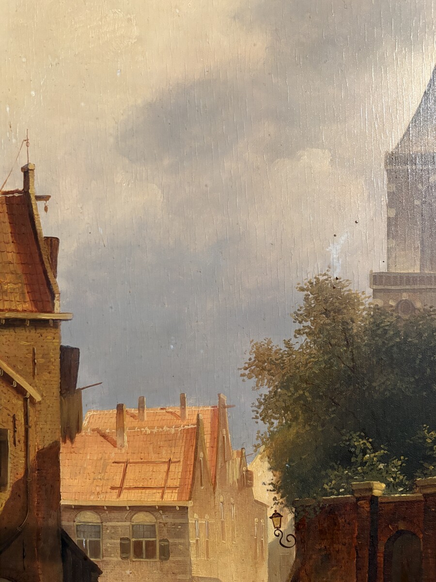 Painting ‘View of an Old Dutch Town’ oil on panel, 19th century Decorative painting in a large gilded frame depicting an old town, a street with old houses, a church, a gate with a municipal garden and various figures. 