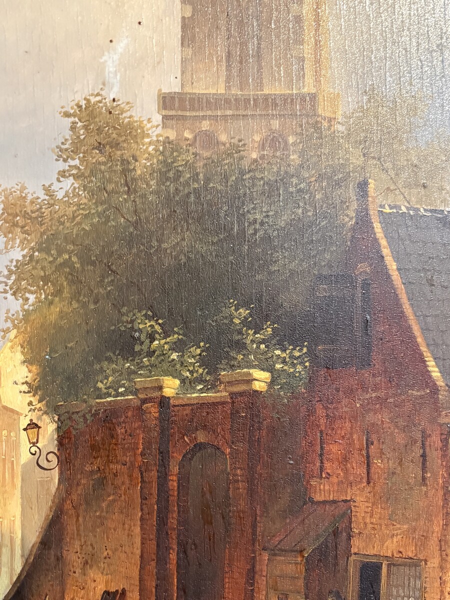 Painting ‘View of an Old Dutch Town’ oil on panel, 19th century Decorative painting in a large gilded frame depicting an old town, a street with old houses, a church, a gate with a municipal garden and various figures. 