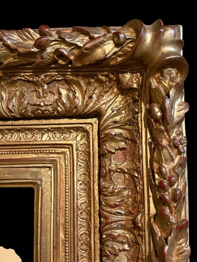 Painting ‘View of an Old Dutch Town’ oil on panel, 19th century Decorative painting in a large gilded frame depicting an old town, a street with old houses, a church, a gate with a municipal garden and various figures. 