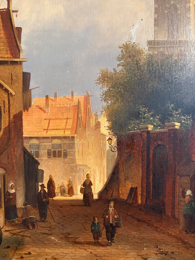 Painting ‘View of an Old Dutch Town’ oil on panel, 19th century Decorative painting in a large gilded frame depicting an old town, a street with old houses, a church, a gate with a municipal garden and various figures.