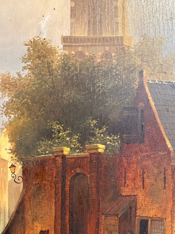 Painting ‘View of an Old Dutch Town’ oil on panel, 19th century Decorative painting in a large gilded frame depicting an old town, a street with old houses, a church, a gate with a municipal garden and various figures.
