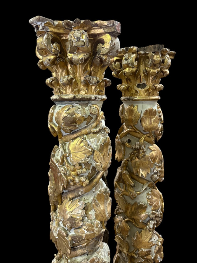 Pair of 17th-century Baroque twisted columns Highly decorative columns adorned with vines, birds and Corinthian capitals covered with antique gilding and polychrome decoration Columns in good condition with wear to the wood, gilding and polychrome.