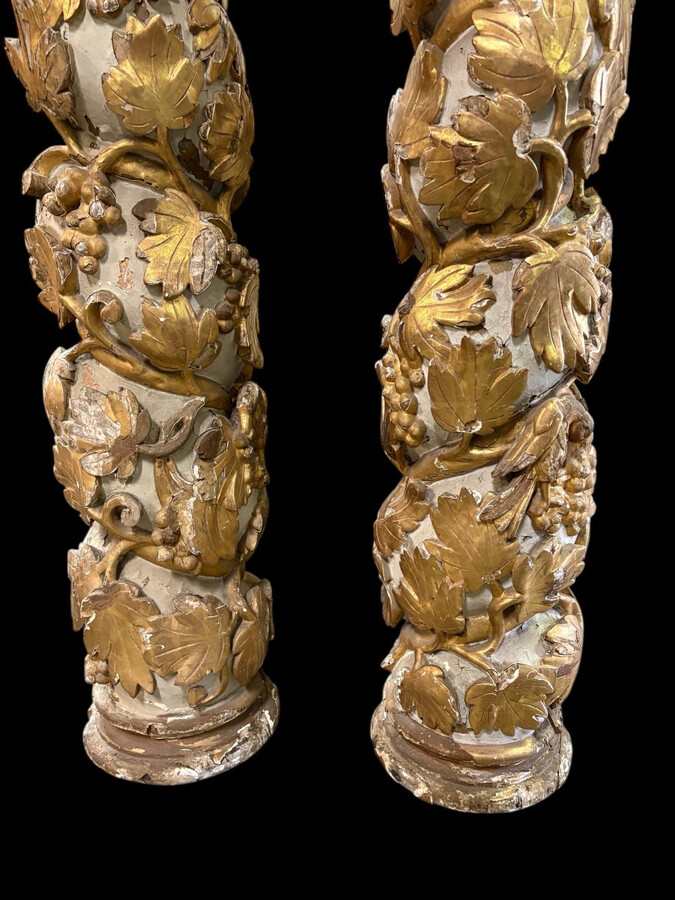 Pair of 17th-century Baroque twisted columns Highly decorative columns adorned with vines, birds and Corinthian capitals covered with antique gilding and polychrome decoration Columns in good condition with wear to the wood, gilding and polychrome.