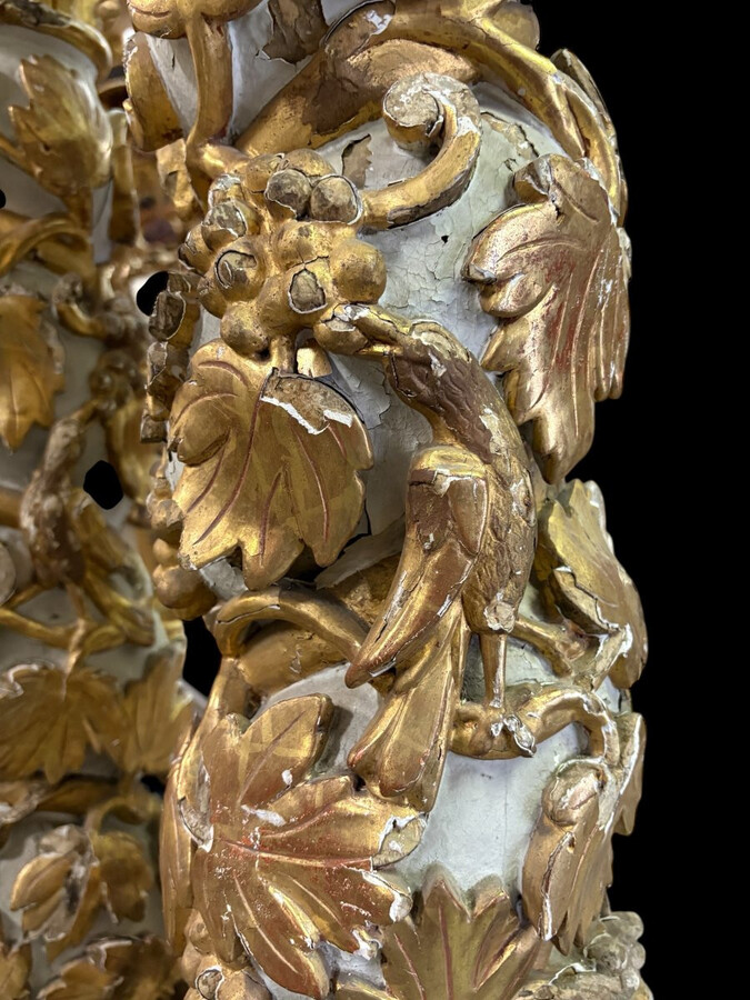 Pair of 17th-century Baroque twisted columns Highly decorative columns adorned with vines, birds and Corinthian capitals covered with antique gilding and polychrome decoration Columns in good condition with wear to the wood, gilding and polychrome.