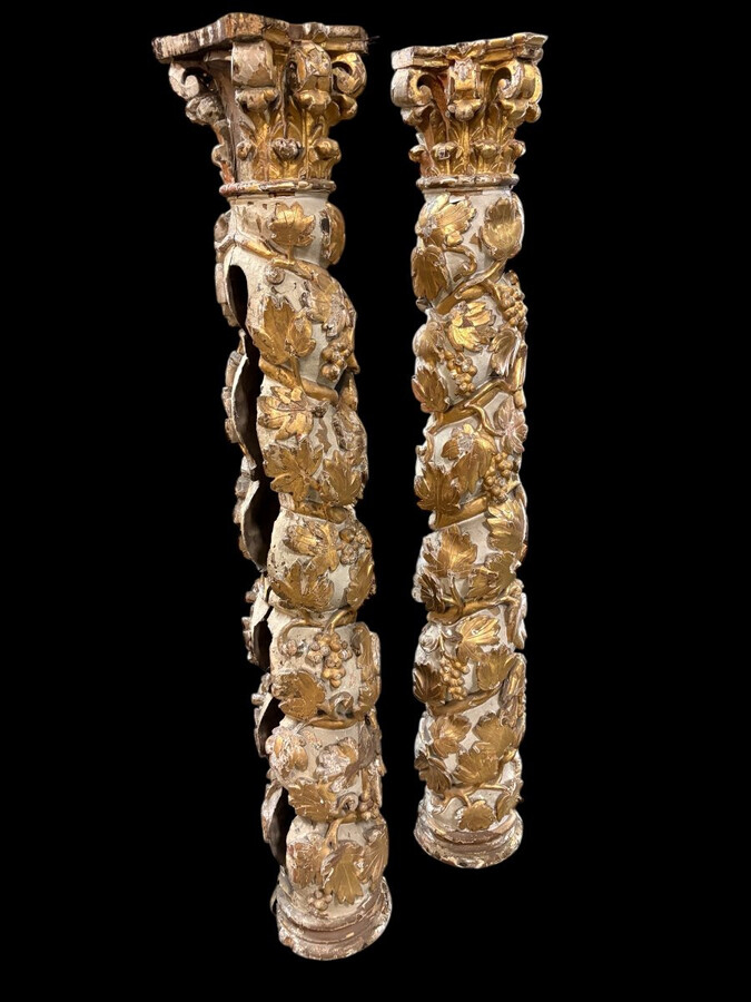 Pair of 17th-century Baroque twisted columns Highly decorative columns adorned with vines, birds and Corinthian capitals covered with antique gilding and polychrome decoration Columns in good condition with wear to the wood, gilding and polychrome.