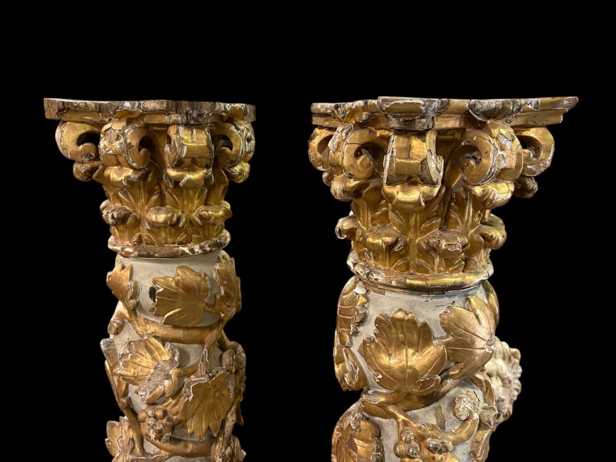 Pair of 17th-century Baroque twisted columns Highly decorative columns adorned with vines, birds and Corinthian capitals covered with antique gilding and polychrome decoration Columns in good condition with wear to the wood, gilding and polychrome.