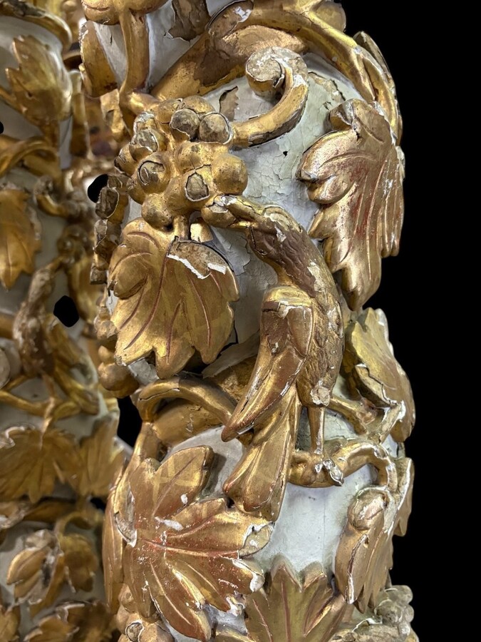 Pair of 17th-century Baroque twisted columns Highly decorative columns adorned with vines, birds and Corinthian capitals covered with antique gilding and polychrome decoration Columns in good condition with wear to the wood, gilding and polychrome.