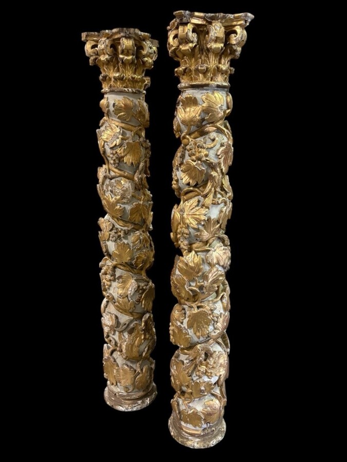 Pair of 17th-century Baroque twisted columns Highly decorative columns adorned with vines, birds and Corinthian capitals covered with antique gilding and polychrome decoration Columns in good condition with wear to the wood, gilding and polychrome.