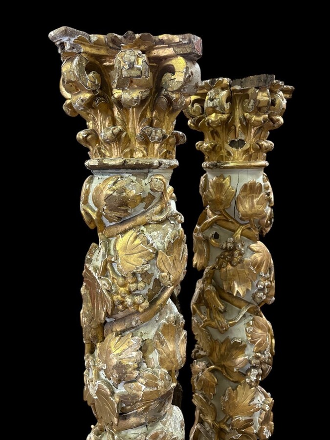Pair of 17th-century Baroque twisted columns Highly decorative columns adorned with vines, birds and Corinthian capitals covered with antique gilding and polychrome decoration Columns in good condition with wear to the wood, gilding and polychrome.
