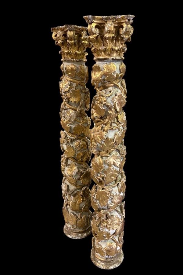 Pair of 17th-century Baroque twisted columns Highly decorative columns adorned with vines, birds and Corinthian capitals covered with antique gilding and polychrome decoration Columns in good condition with wear to the wood, gilding and polychrome.