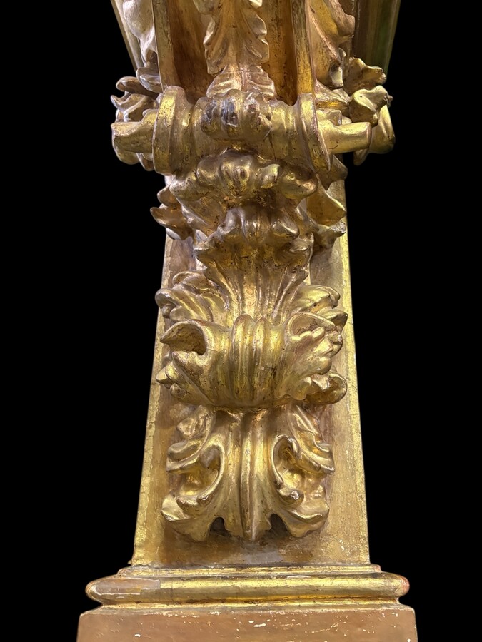 Pair of 17th-century Italian Baroque consoles. Decorative consoles carved in wood, gilded/polychrome, with garlands, fruit, angel heads and decorative ornaments. Ideal for creating a beautiful wall console. Both are in good condition, with normal signs of