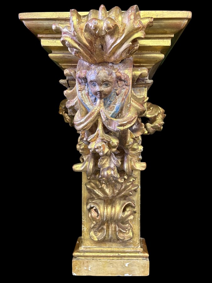 Pair of 17th-century Italian Baroque consoles. Decorative consoles carved in wood, gilded/polychrome, with garlands, fruit, angel heads and decorative ornaments. Ideal for creating a beautiful wall console. Both are in good condition, with normal signs of