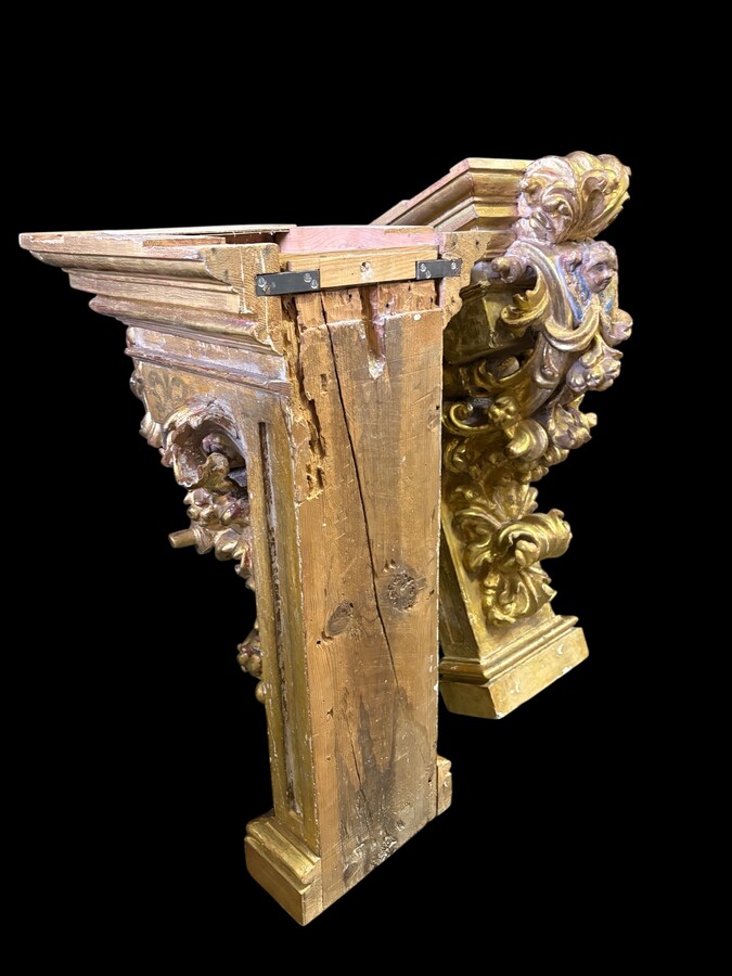 Pair of 17th-century Italian Baroque consoles. Decorative consoles carved in wood, gilded/polychrome, with garlands, fruit, angel heads and decorative ornaments. Ideal for creating a beautiful wall console. Both are in good condition, with normal signs of