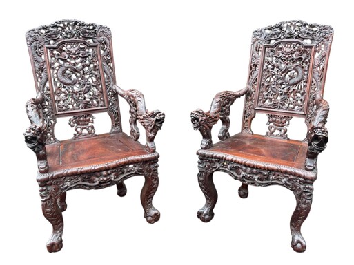 Pair of 19th century Asian hardwood armchairs. Very finely carved and detailed armchairs, decorated with dragons and ornaments. Heavy armchairs in very good condition. Dimensions: Height: 103.5 cm Width: 61.5 cm Depth: 62 cm Seat height: 41.5 cm
