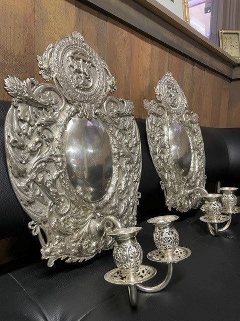 Pair of 19th century silver-plated sconces / candleholders. Decorative Renaissance style sconces with 2 candles. 1 of the sconces is much lighter and possibly silver. Dimensions: Height : 54 cm Width : 34 cm Depth : 14 cm In good condition