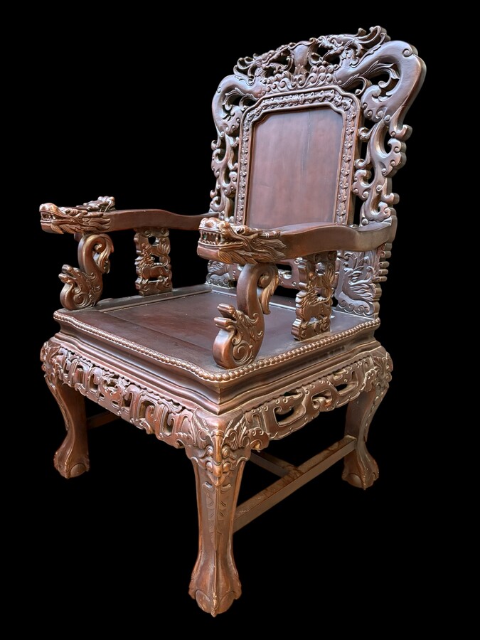 Pair of Asian solid wood armchairs, 20th century Decorative armchairs adorned with magnificent dragons and dragon heads as armrests. Dimensions: Height: 119 cm Width: 76 cm Depth: 67 cm Heavy solid wood armchairs in good condition, 20th century.