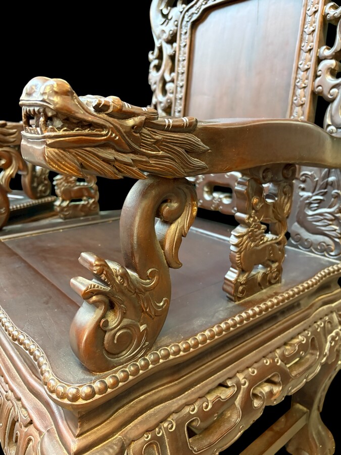 Pair of Asian solid wood armchairs, 20th century Decorative armchairs adorned with magnificent dragons and dragon heads as armrests. Dimensions: Height: 119 cm Width: 76 cm Depth: 67 cm Heavy solid wood armchairs in good condition, 20th century.