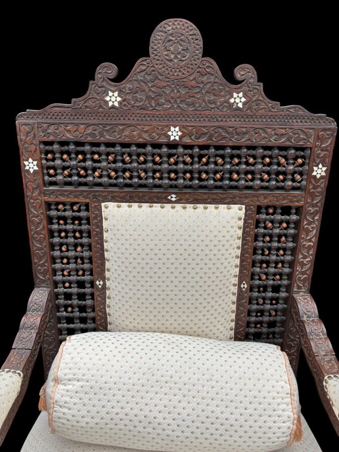Pair of Carved Armchairs With Ebony And Mother Of Pearl Inlays. Syria, 19th century. Very decorative Orientalist armchairs upholstered in a beautiful fabric with cushion and scroll. Woodwork in good condition with a few chips and inlays due to age.