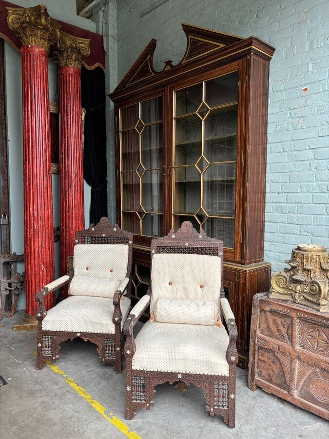 Pair of Carved Armchairs With Ebony And Mother Of Pearl Inlays. Syria, 19th century. Very decorative Orientalist armchairs upholstered in a beautiful fabric with cushion and scroll. Woodwork in good condition with a few chips and inlays due to age.