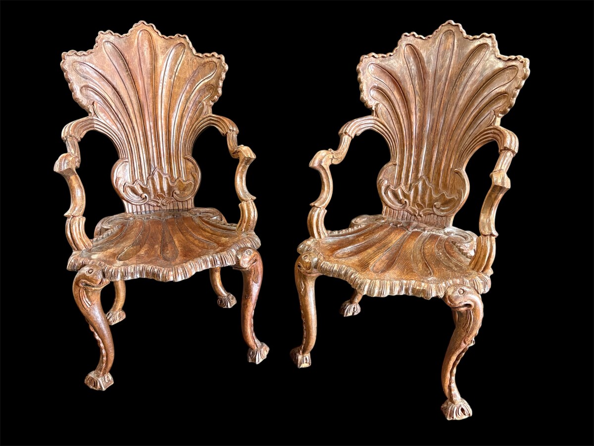 Pair Of Carved Walnut Cave Armchairs 20th C. A very fine pair of Venice carved walnut cave armchairs with a small table. The armchairs, shell-shaped, are all done in the typical style for decoration that was the fashion in Venice in the 19th century. 