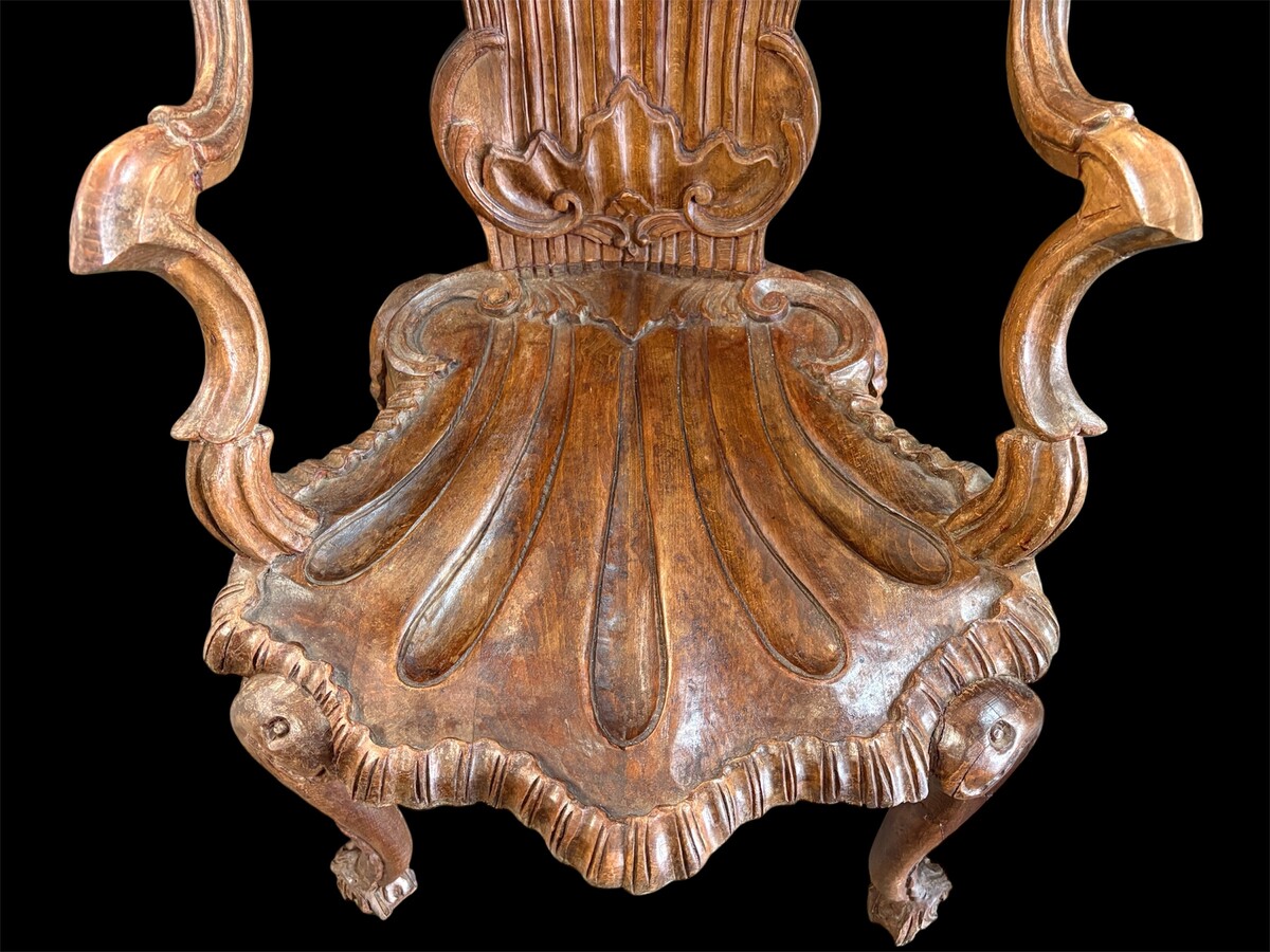 Pair Of Carved Walnut Cave Armchairs 20th C. A very fine pair of Venice carved walnut cave armchairs with a small table. The armchairs, shell-shaped, are all done in the typical style for decoration that was the fashion in Venice in the 19th century. 