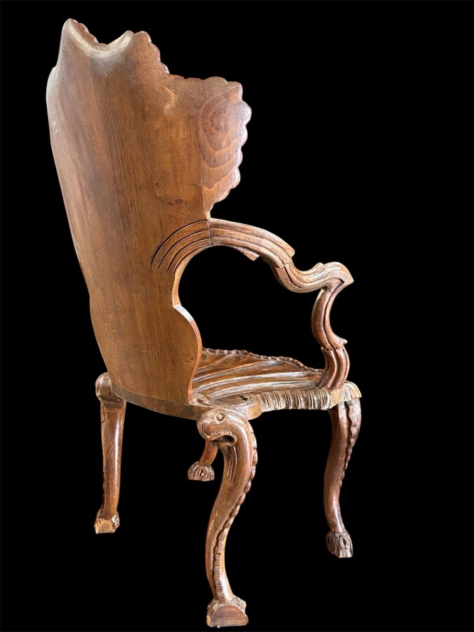 Pair Of Carved Walnut Cave Armchairs 20th C. A very fine pair of Venice carved walnut cave armchairs with a small table. The armchairs, shell-shaped, are all done in the typical style for decoration that was the fashion in Venice in the 19th century. 
