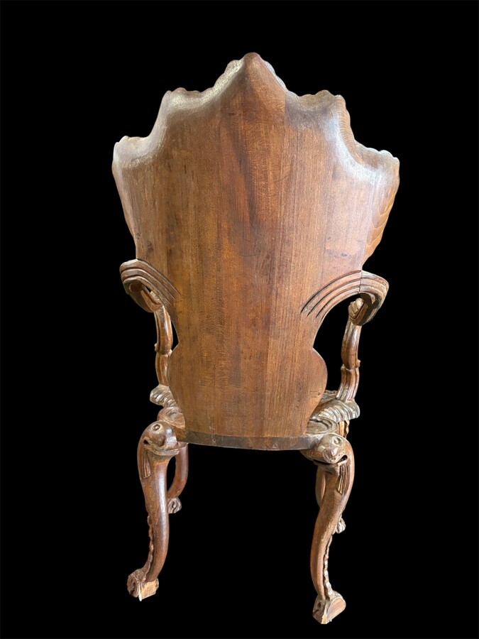 Pair Of Carved Walnut Cave Armchairs 20th C. A very fine pair of Venice carved walnut cave armchairs with a small table. The armchairs, shell-shaped, are all done in the typical style for decoration that was the fashion in Venice in the 19th century. 