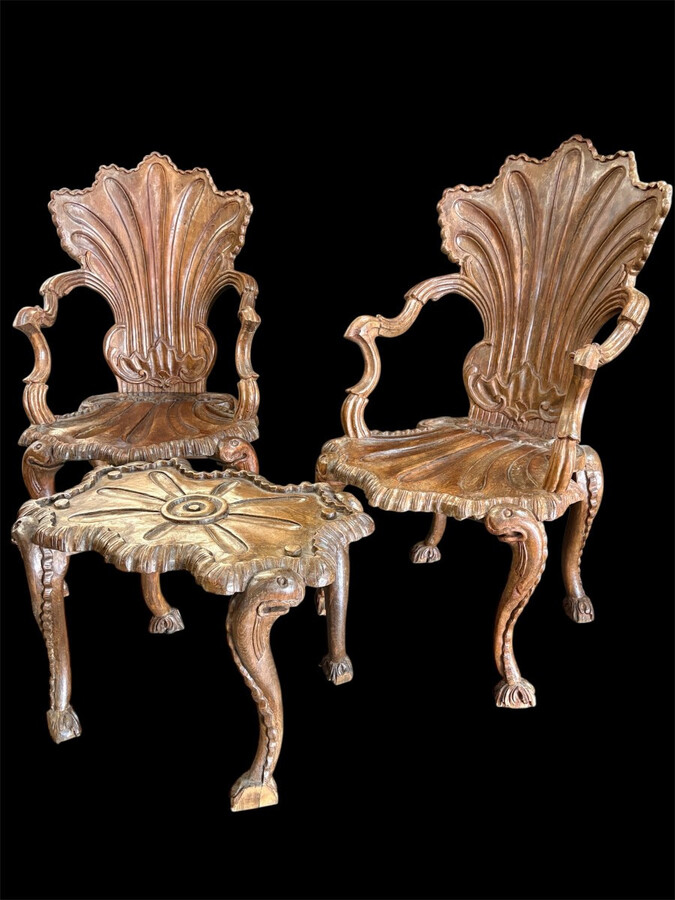 Pair Of Carved Walnut Cave Armchairs 20th C. A very fine pair of Venice carved walnut cave armchairs with a small table. The armchairs, shell-shaped, are all done in the typical style for decoration that was the fashion in Venice in the 19th century.