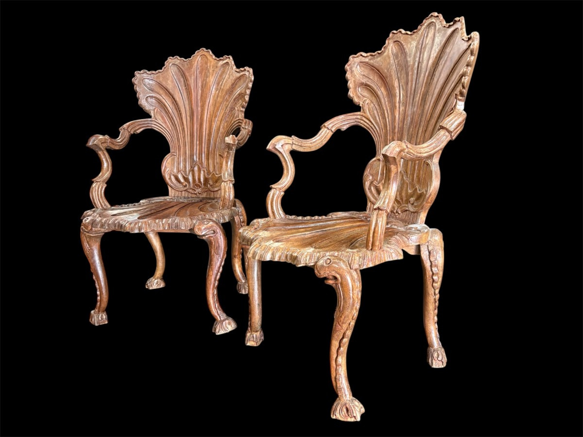 Pair Of Carved Walnut Cave Armchairs 20th C. A very fine pair of Venice carved walnut cave armchairs with a small table. The armchairs, shell-shaped, are all done in the typical style for decoration that was the fashion in Venice in the 19th century.