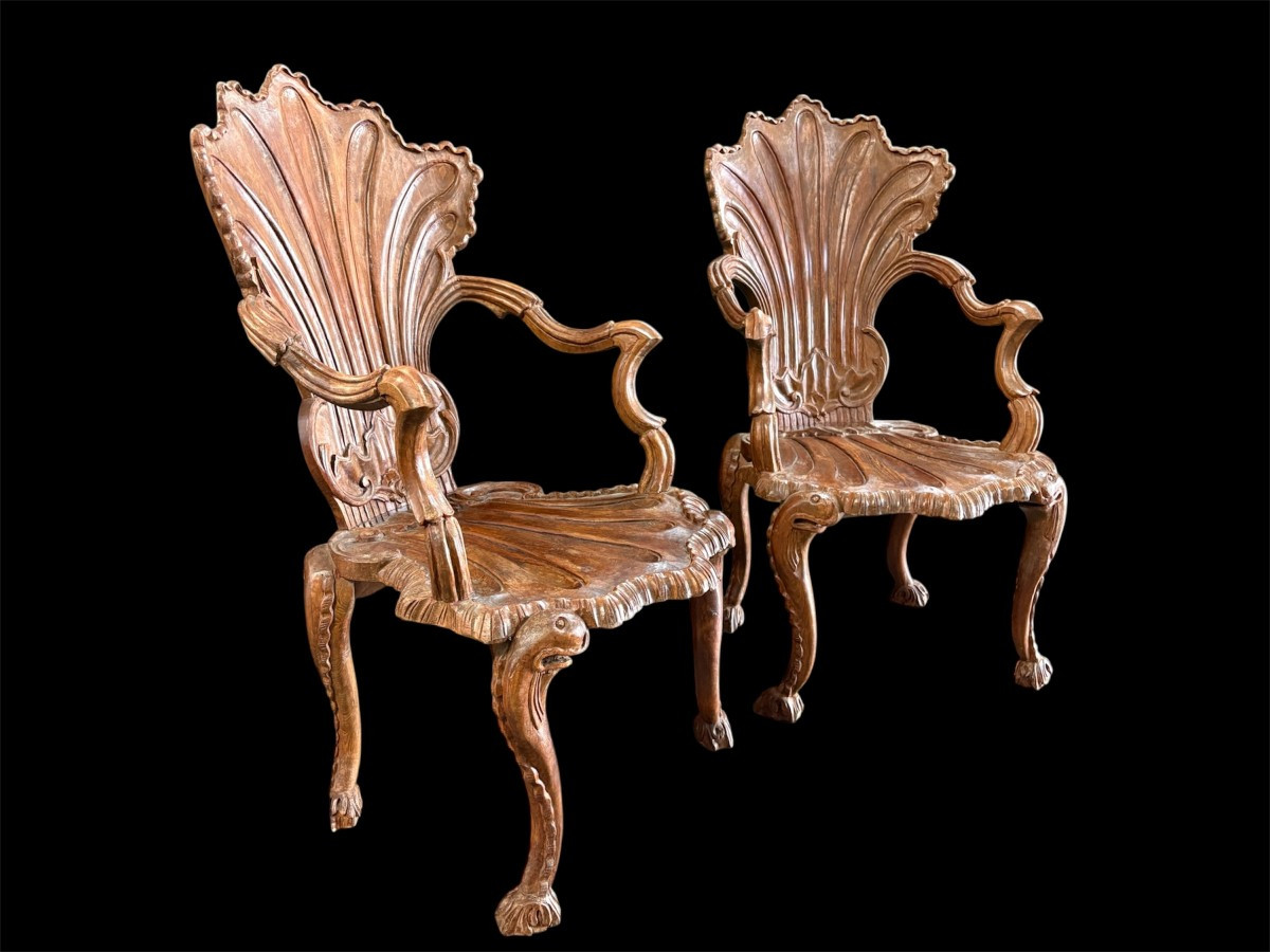 Pair Of Carved Walnut Cave Armchairs 20th C. A very fine pair of Venice carved walnut cave armchairs with a small table. The armchairs, shell-shaped, are all done in the typical style for decoration that was the fashion in Venice in the 19th century.