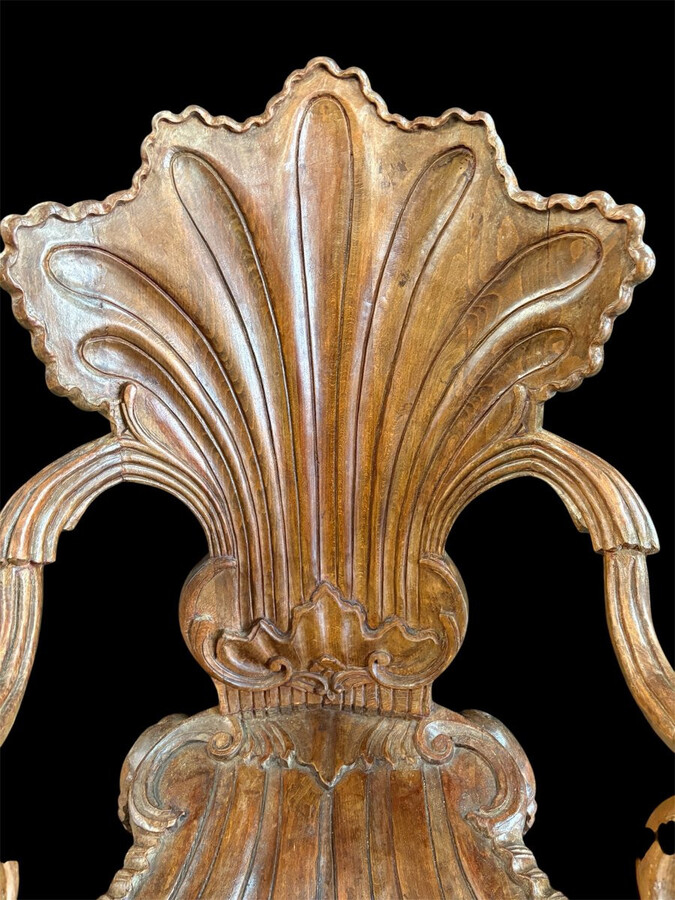 Pair Of Carved Walnut Cave Armchairs 20th C. A very fine pair of Venice carved walnut cave armchairs with a small table. The armchairs, shell-shaped, are all done in the typical style for decoration that was the fashion in Venice in the 19th century.
