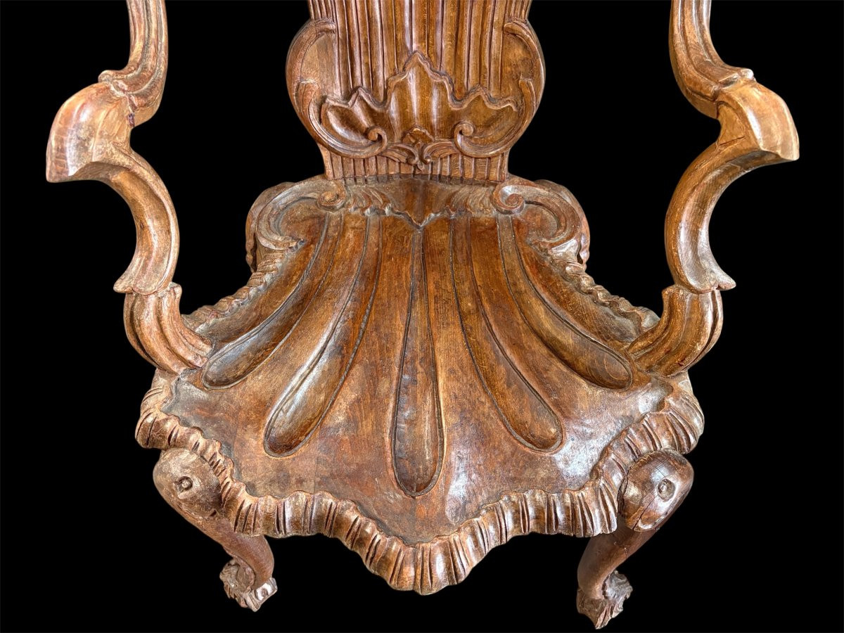 Pair Of Carved Walnut Cave Armchairs 20th C. A very fine pair of Venice carved walnut cave armchairs with a small table. The armchairs, shell-shaped, are all done in the typical style for decoration that was the fashion in Venice in the 19th century.