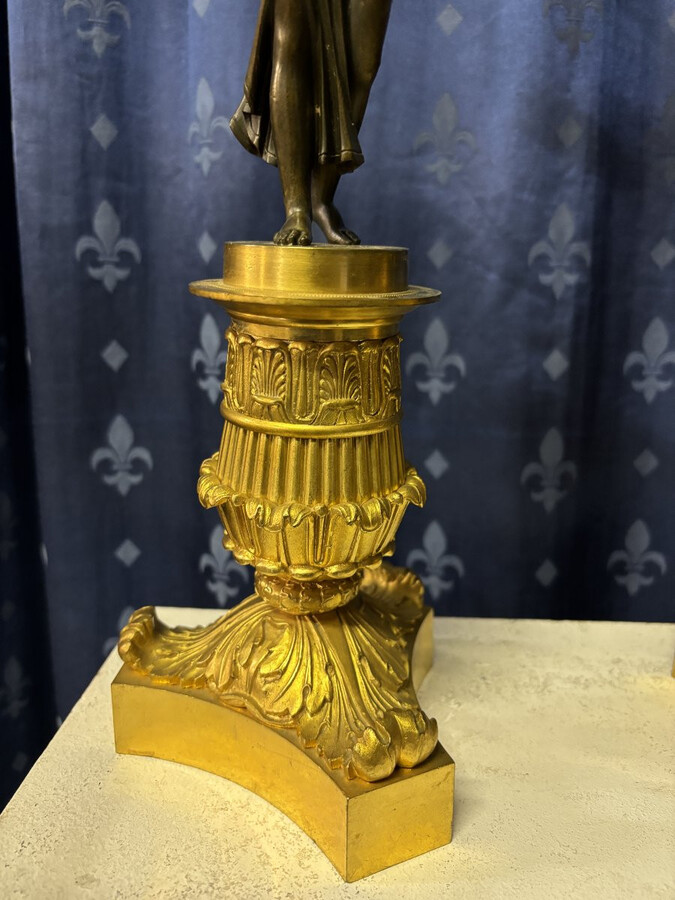 Pair of elegant bronze candelabra in the Empire style 19th century Pair of Empire period candelabra decorated with a winged man and a flame carrying a torch and four candles. They are both in very good condition 