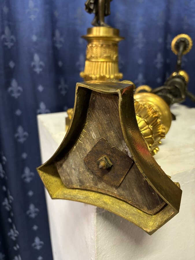 Pair of elegant bronze candelabra in the Empire style 19th century Pair of Empire period candelabra decorated with a winged man and a flame carrying a torch and four candles. They are both in very good condition 