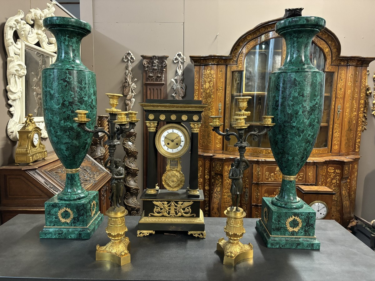 Pair of elegant bronze candelabra in the Empire style 19th century Pair of Empire period candelabra decorated with a winged man and a flame carrying a torch and four candles. They are both in very good condition 