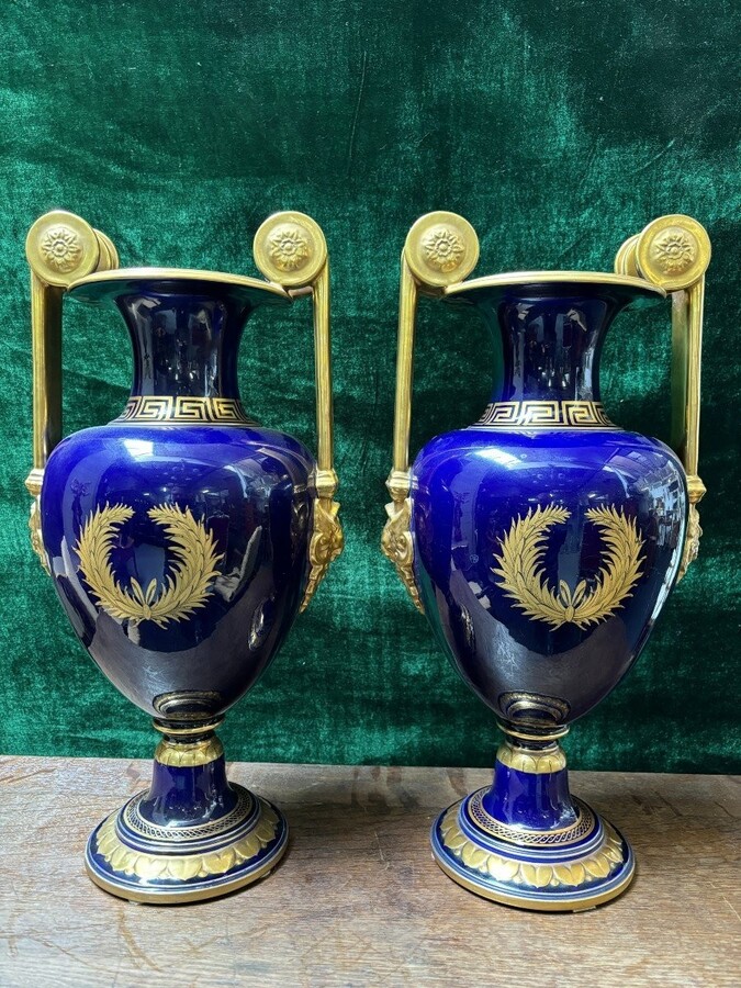  Pair of Empire style porcelain vases Sèvres , 20th Century Pair of vases with romantic paintings in blue and gilt tones. Signed by G.Etemod and underneath marked with Sèvres sign Dimensions : Height : 55 cm Width : 28 cm Diameter foot : 18 cm