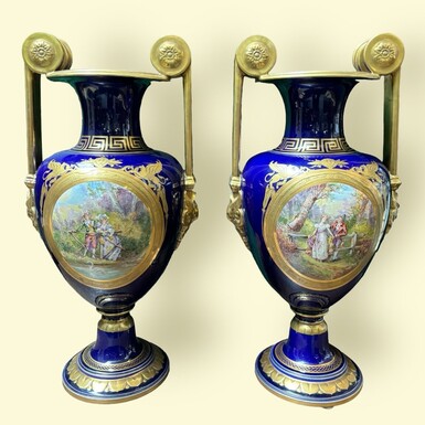 Pair of Empire style porcelain vases Sèvres , 20th Century Pair of vases with romantic paintings in blue and gilt tones. Signed by G.Etemod and underneath marked with Sèvres sign Dimensions : Height : 55 cm Width : 28 cm Diameter foot : 18 cm In