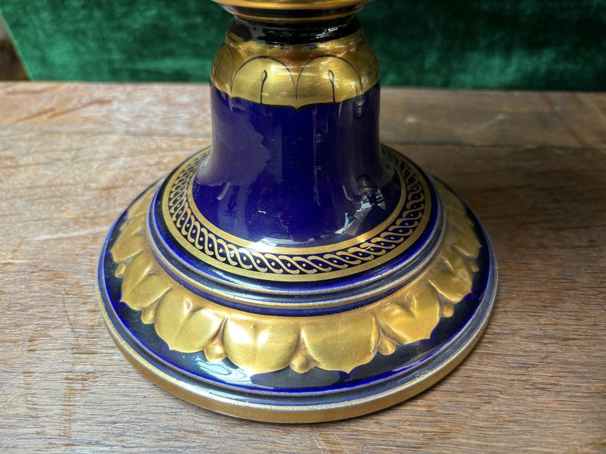 Pair of Empire style porcelain vases Sèvres , 20th Century Pair of vases with romantic paintings in blue and gilt tones. Signed by G.Etemod and underneath marked with Sèvres sign Dimensions : Height : 55 cm Width : 28 cm Diameter foot : 18 cm In