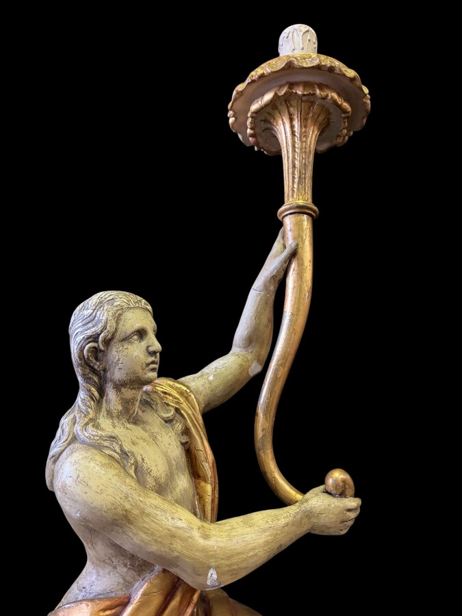 Pair of large 18th-century polychrome/gilded wooden sculptures/torch holders. 18th-century Italian decorative sculptures depicting two kneeling young men, draped in linen cloth and carrying a torch/candelabra. Both are in good condition with nor