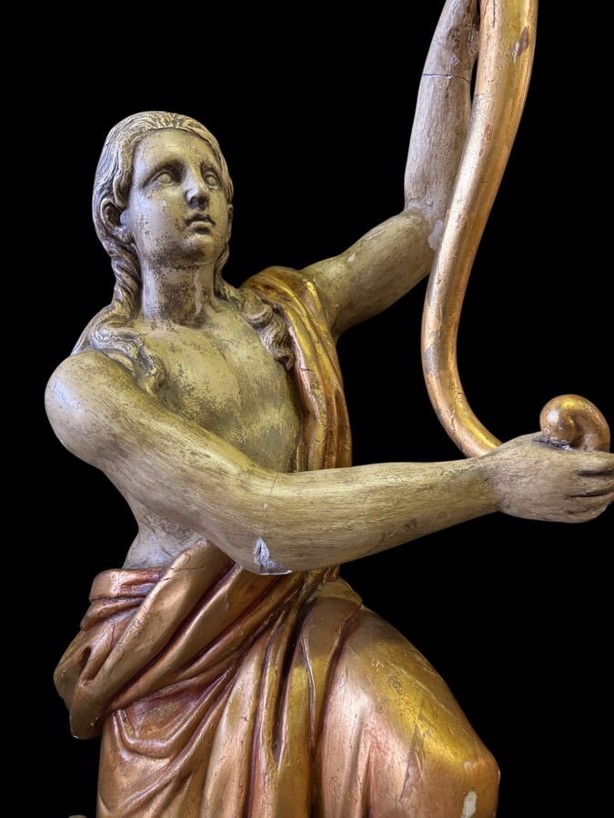 Pair of large 18th-century polychrome/gilded wooden sculptures/torch holders. 18th-century Italian decorative sculptures depicting two kneeling young men, draped in linen cloth and carrying a torch/candelabra. Both are in good condition with nor