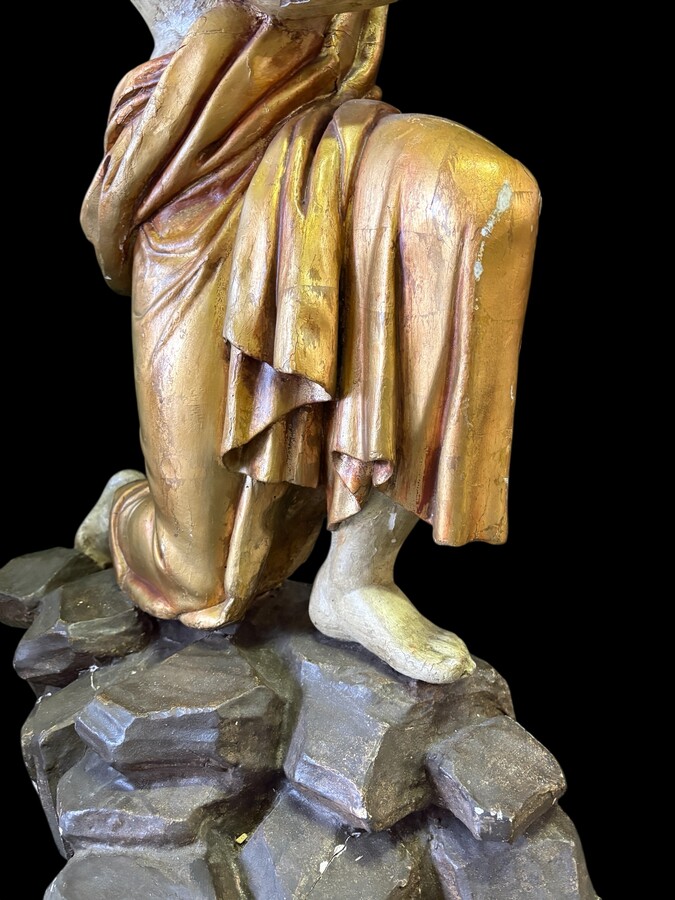 Pair of large 18th-century polychrome/gilded wooden sculptures/torch holders. 18th-century Italian decorative sculptures depicting two kneeling young men, draped in linen cloth and carrying a torch/candelabra. Both are in good condition with nor