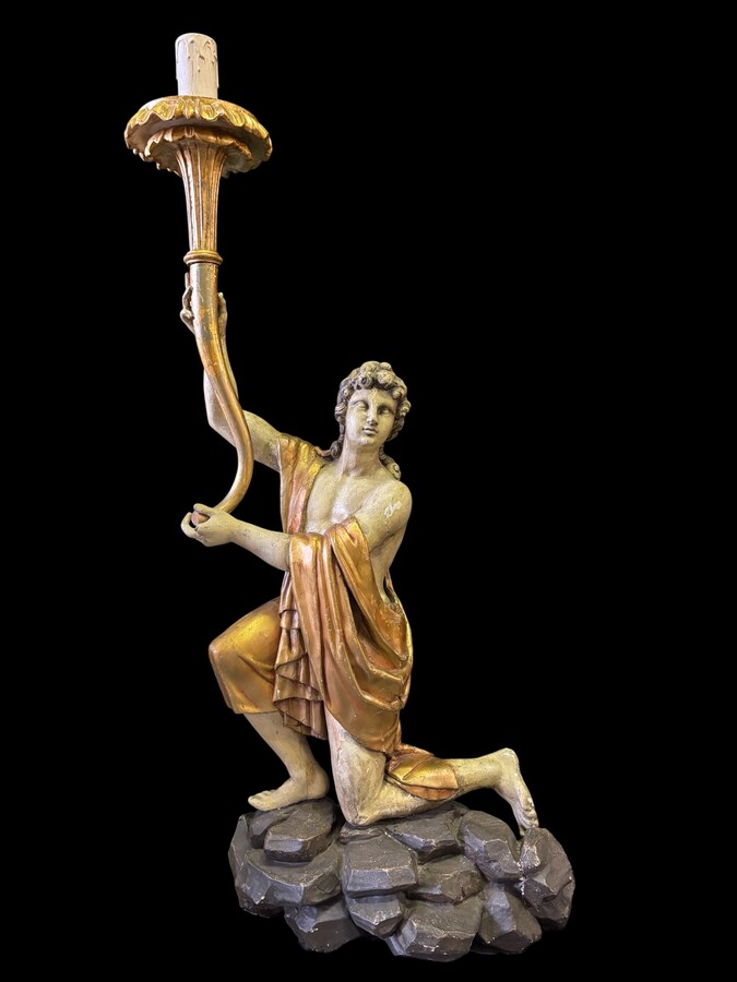 Pair of large 18th-century polychrome/gilded wooden sculptures/torch holders. 18th-century Italian decorative sculptures depicting two kneeling young men, draped in linen cloth and carrying a torch/candelabra. Both are in good condition with nor