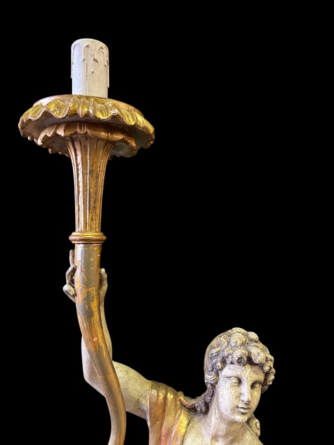 Pair of large 18th-century polychrome/gilded wooden sculptures/torch holders. 18th-century Italian decorative sculptures depicting two kneeling young men, draped in linen cloth and carrying a torch/candelabra. Both are in good condition with nor