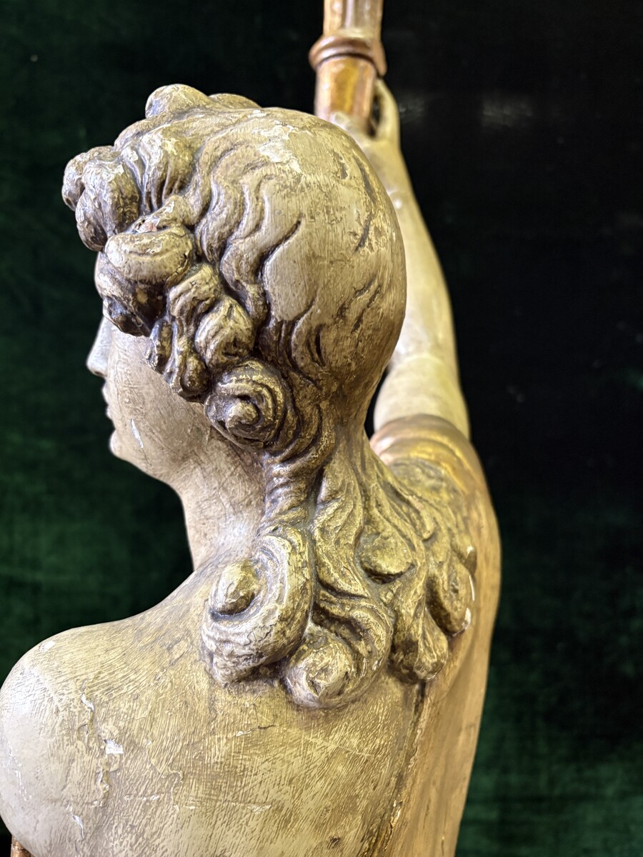 Pair of large 18th-century polychrome/gilded wooden sculptures/torch holders. 18th-century Italian decorative sculptures depicting two kneeling young men, draped in linen cloth and carrying a torch/candelabra. Both are in good condition with nor