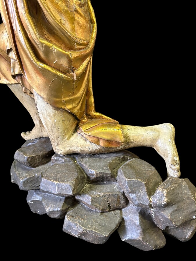 Pair of large 18th-century polychrome/gilded wooden sculptures/torch holders. 18th-century Italian decorative sculptures depicting two kneeling young men, draped in linen cloth and carrying a torch/candelabra. Both are in good condition with nor