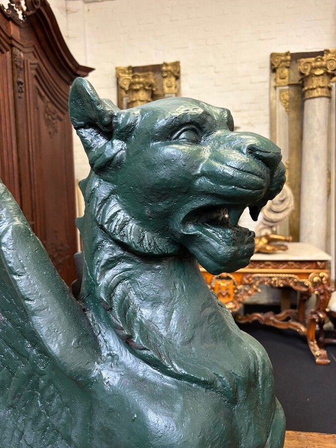 Pair of large, 20th-century cast iron, Empire-style mythological winged lions Highly decorative sculptures for gardens or interiors, with the following dimensions: Height: 83 cm Width: 47 cm Length: 89 cm