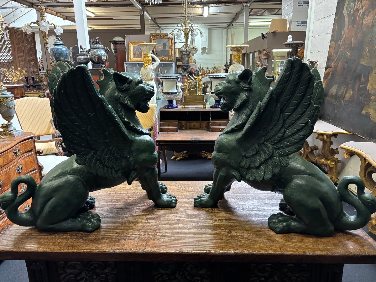 Pair of large, 20th-century cast iron, Empire-style mythological winged lions Highly decorative sculptures for gardens or interiors, with the following dimensions: Height: 83 cm Width: 47 cm Length: 89 cm