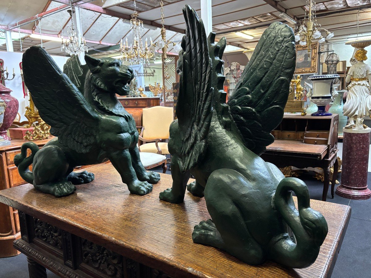 Pair of large, 20th-century cast iron, Empire-style mythological winged lions Highly decorative sculptures for gardens or interiors, with the following dimensions: Height: 83 cm Width: 47 cm Length: 89 cm